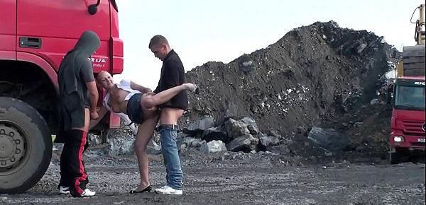  A very cute blonde young lady is fucked in public threesome at a construction site